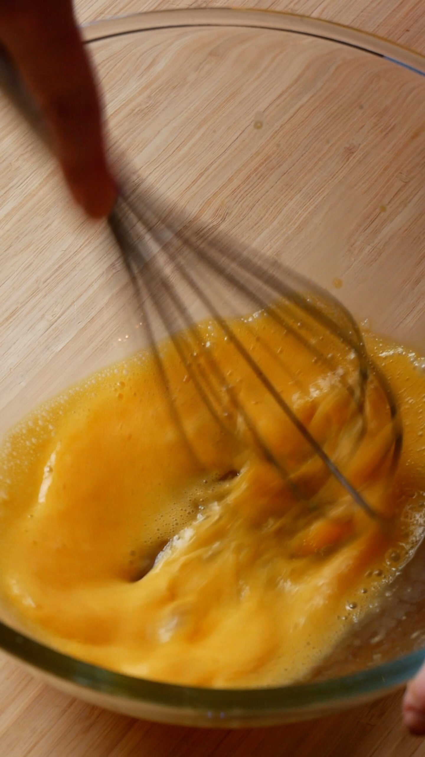 egg yolks in glass bowl have been whisked together. 