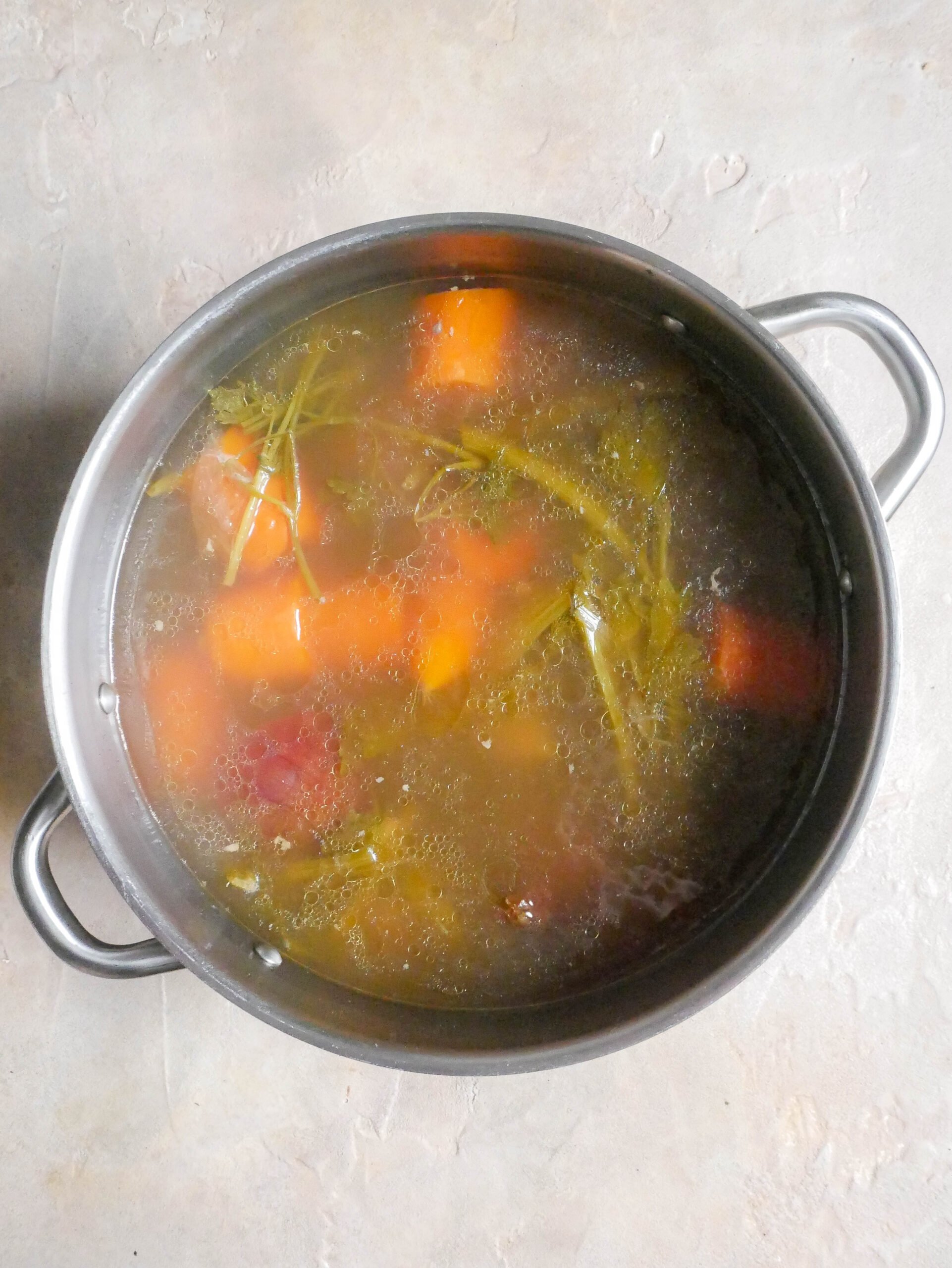 Pot of chicken broth has been cooked