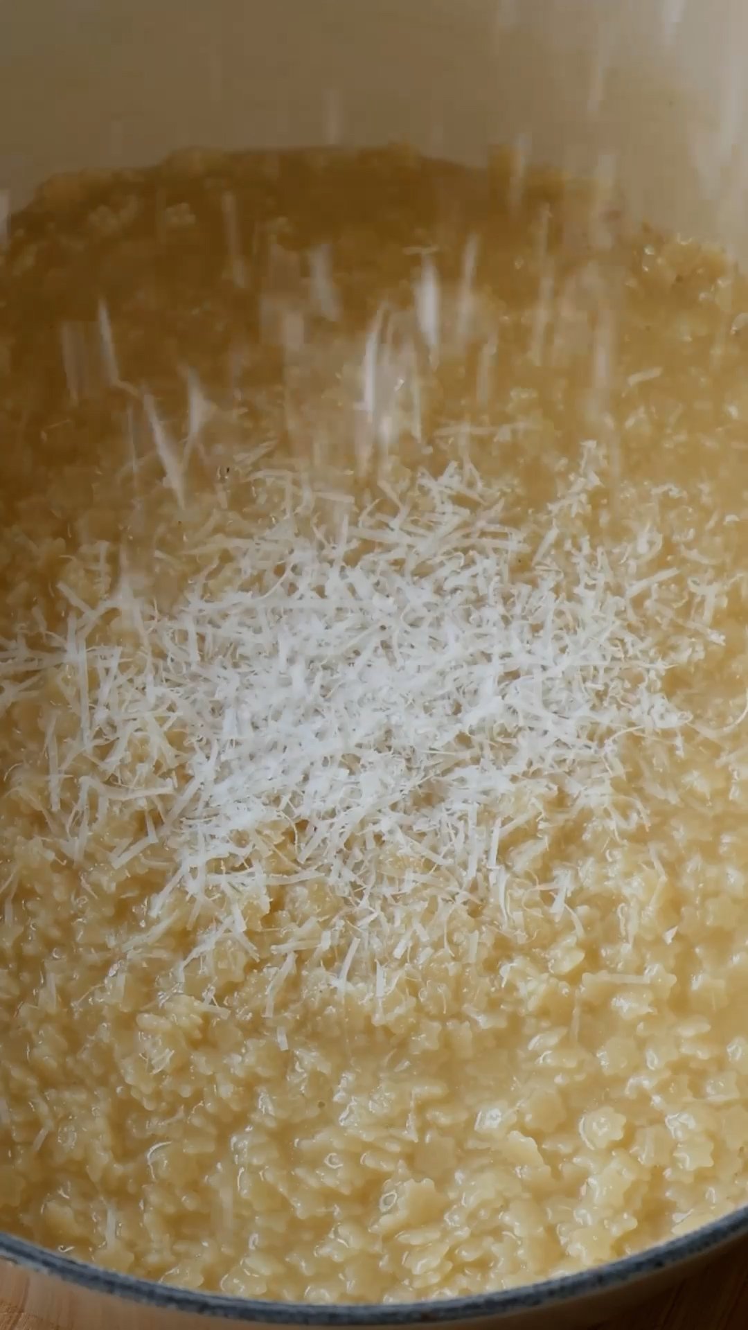 cooked pastina being seasoned with cheese