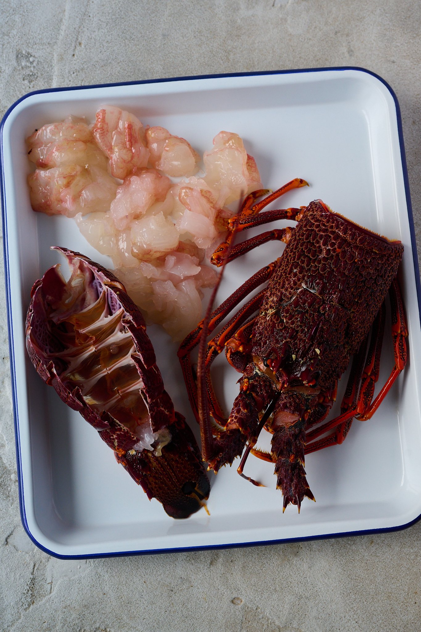 Lobster has been prepped and you can see the lobster tail meat, lobster tail and head.