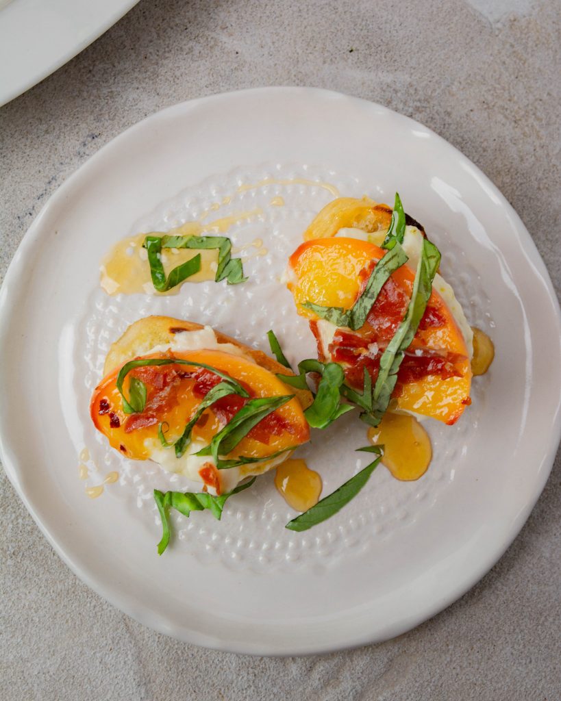 Peach and crispy prosciutto crostini