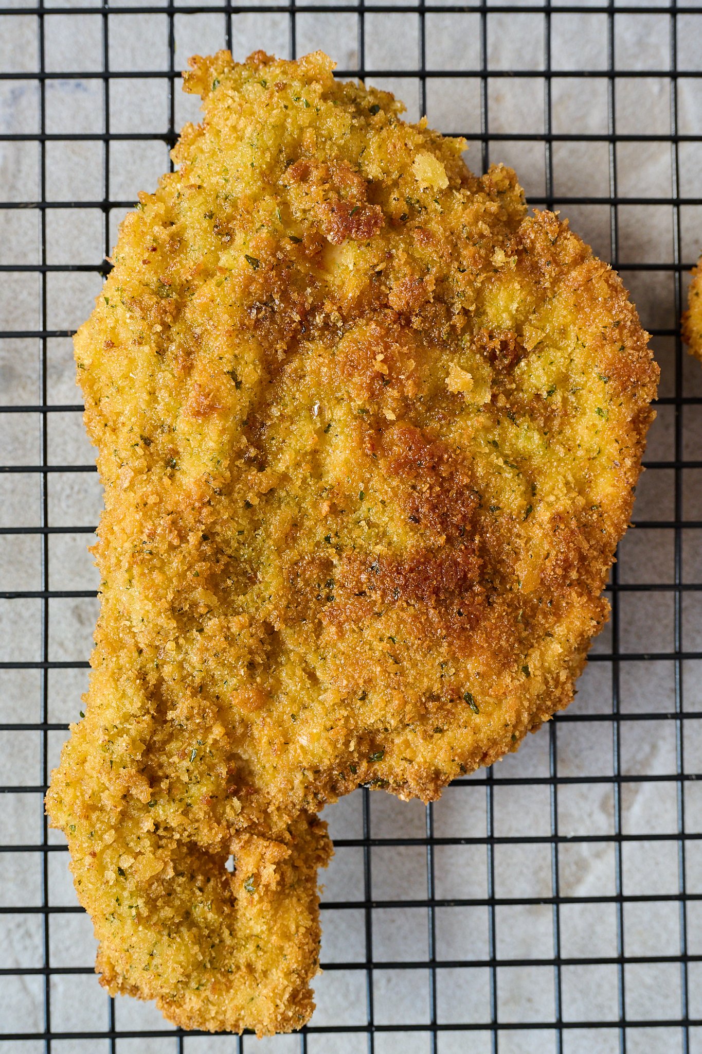 Crispy crumbed chicken lays on cooling rack