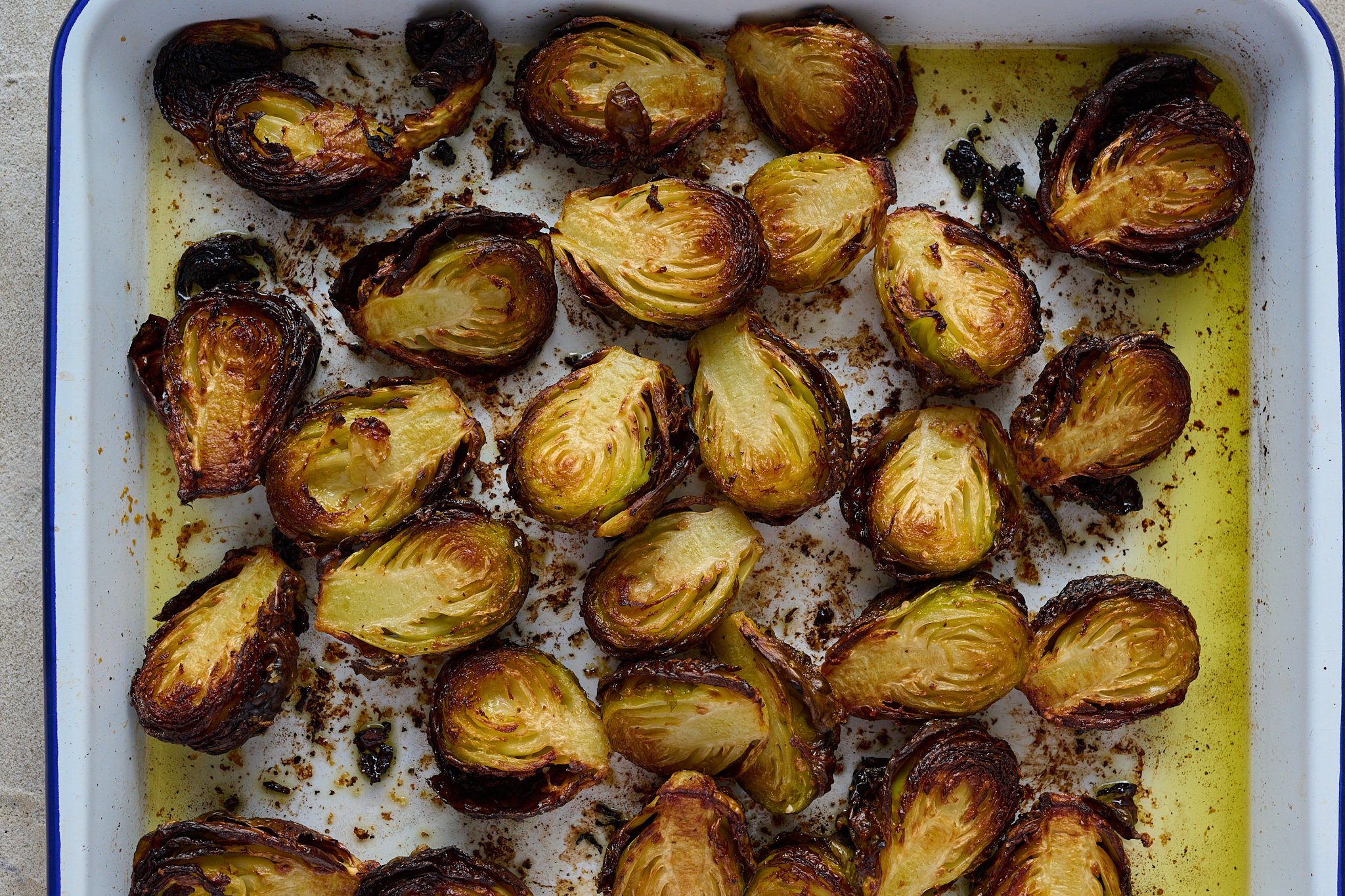 Brussels sprouts are cooked and on roasting tray.