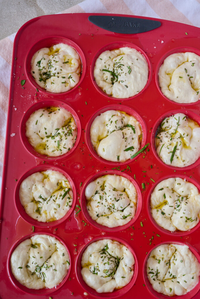 Muffin tin focaccia raw dough before being baked