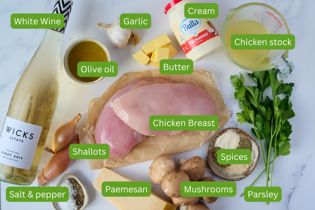 Shot of ingredients laid out onto table. Ingredients in image include white wine, olive oil, shallots, salt and pepper, garlic, butter, chicken breast, parmesan, mushrooms, spices, parsley, chicken stock and cream