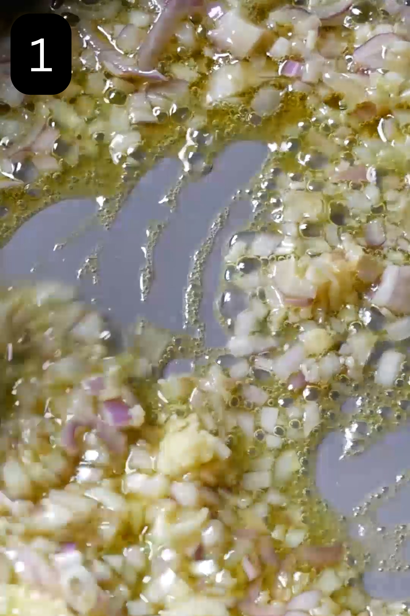 Shallot and garlic frying in pan with olive oil.