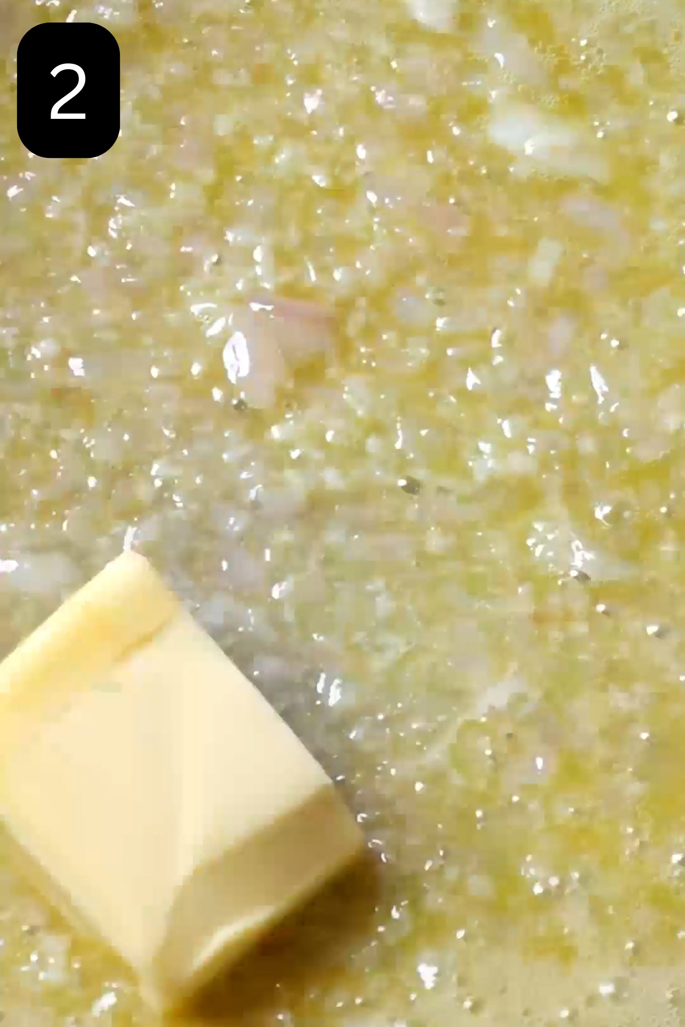 Butter and white wine in pan with shallots and garlic. 