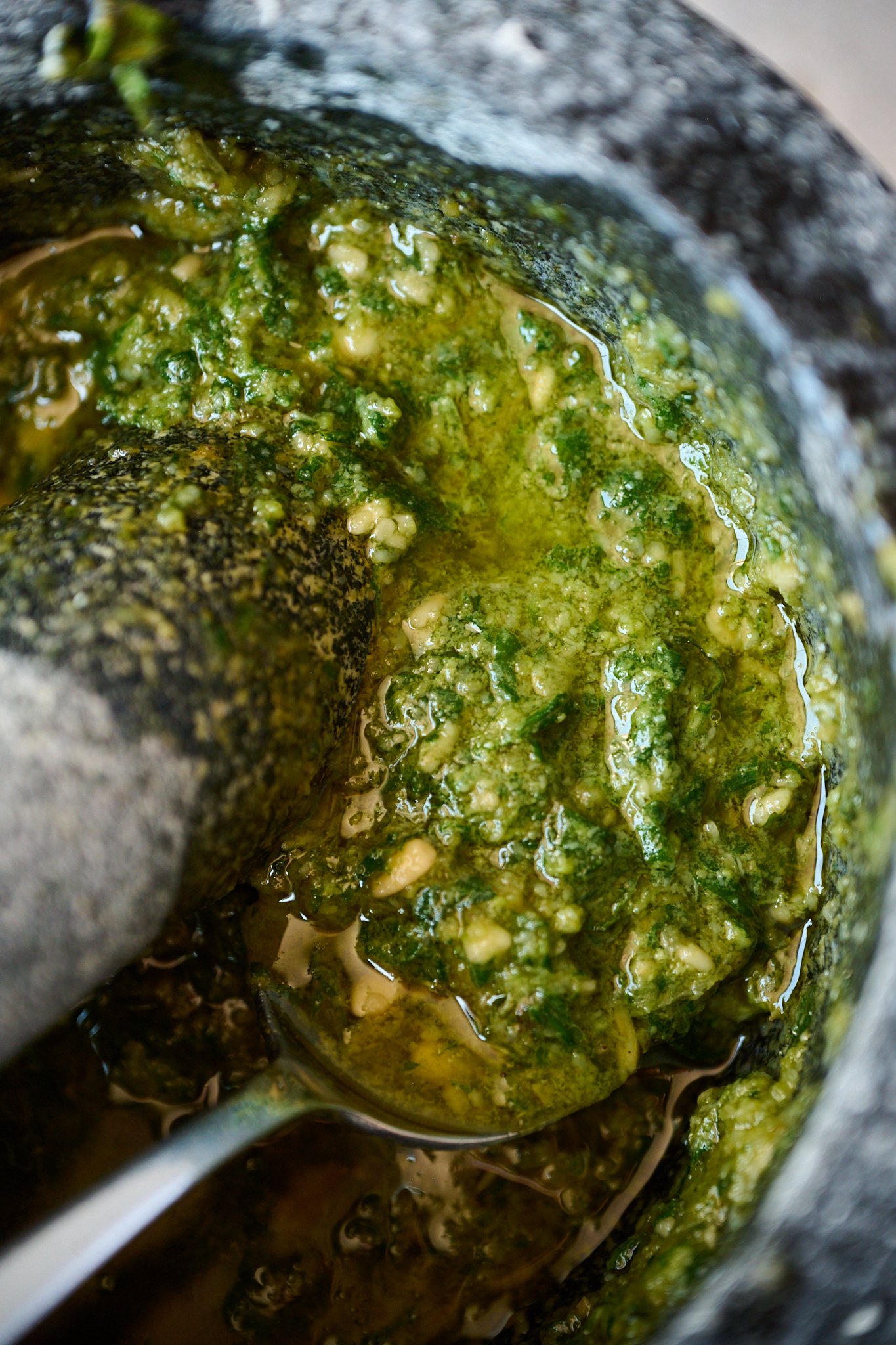 Pesto in black and white mortar and pestle