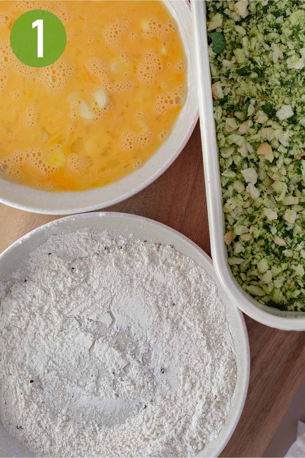 preparing the breading stations of egg and flour.