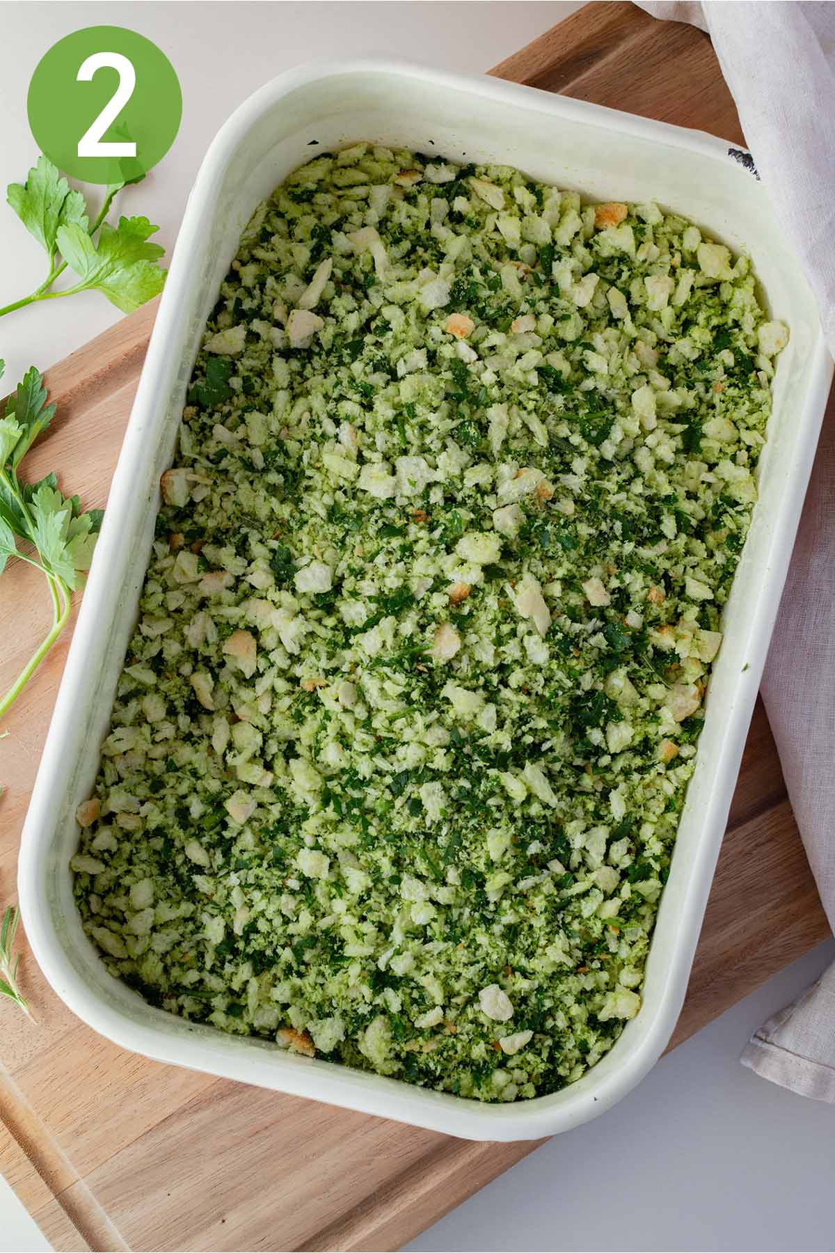 breadcrumbs mixed with herbs in a dish.