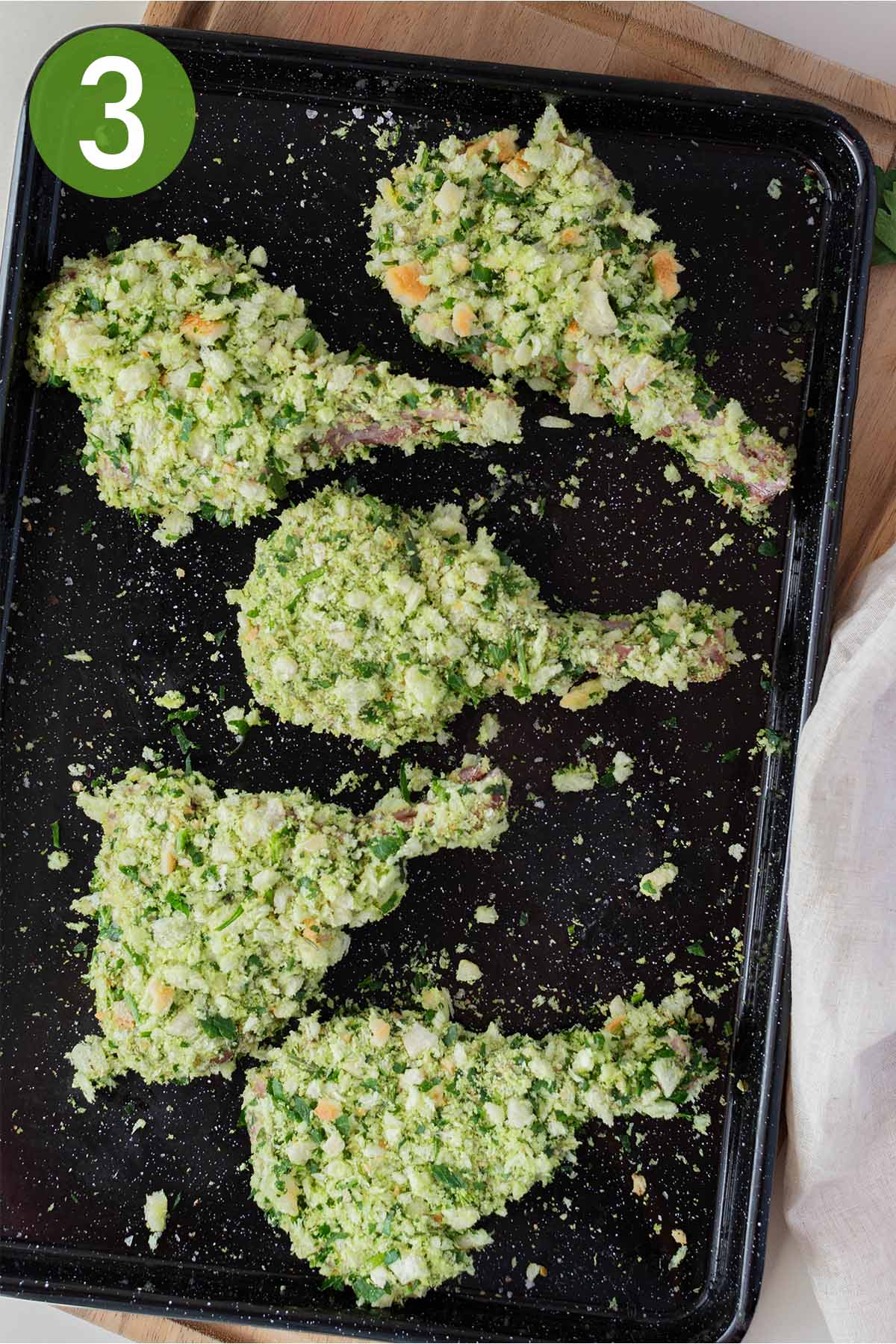 coating lamb cutlets in breadcrumb mixture.