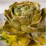 garlic butter artichoke with cheese and herbs.