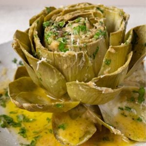 garlic butter artichoke with cheese and herbs.
