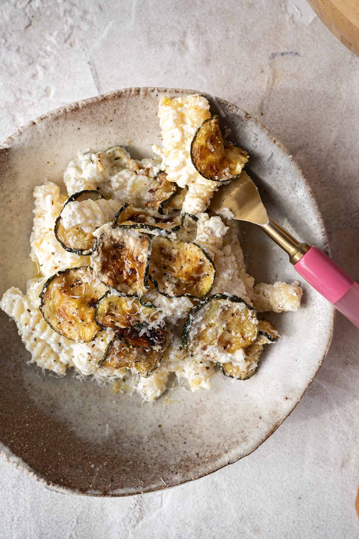 forkful of lemon ricotta pasta on a plate.