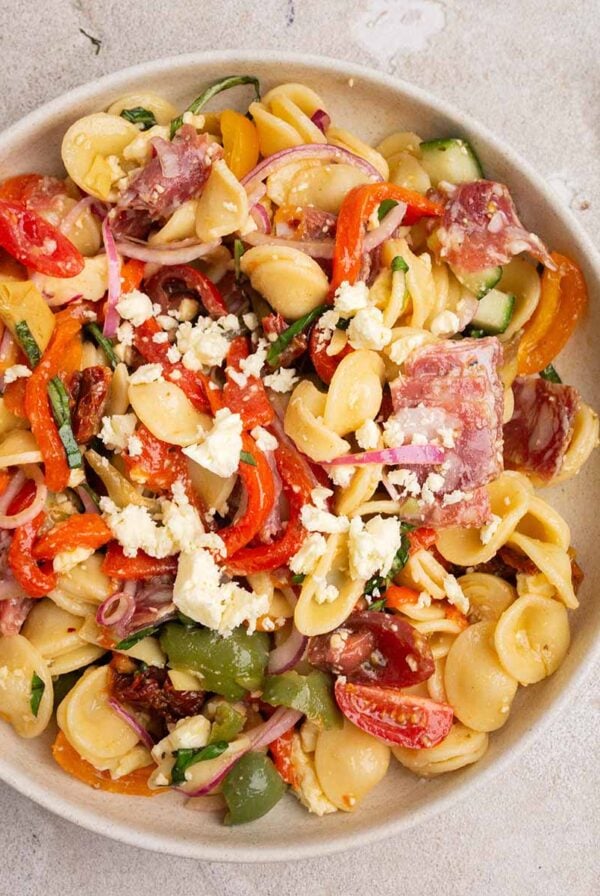 plate of rainbow antipasto pasta salad with a fork.