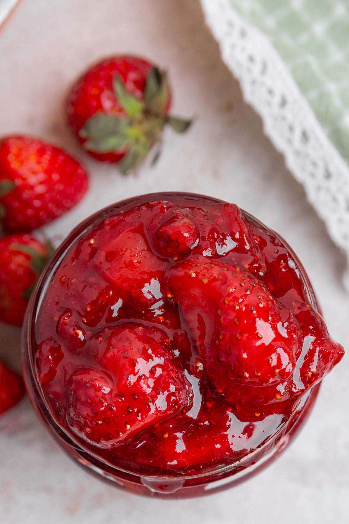 jar of strawberry jam with fresh berries.