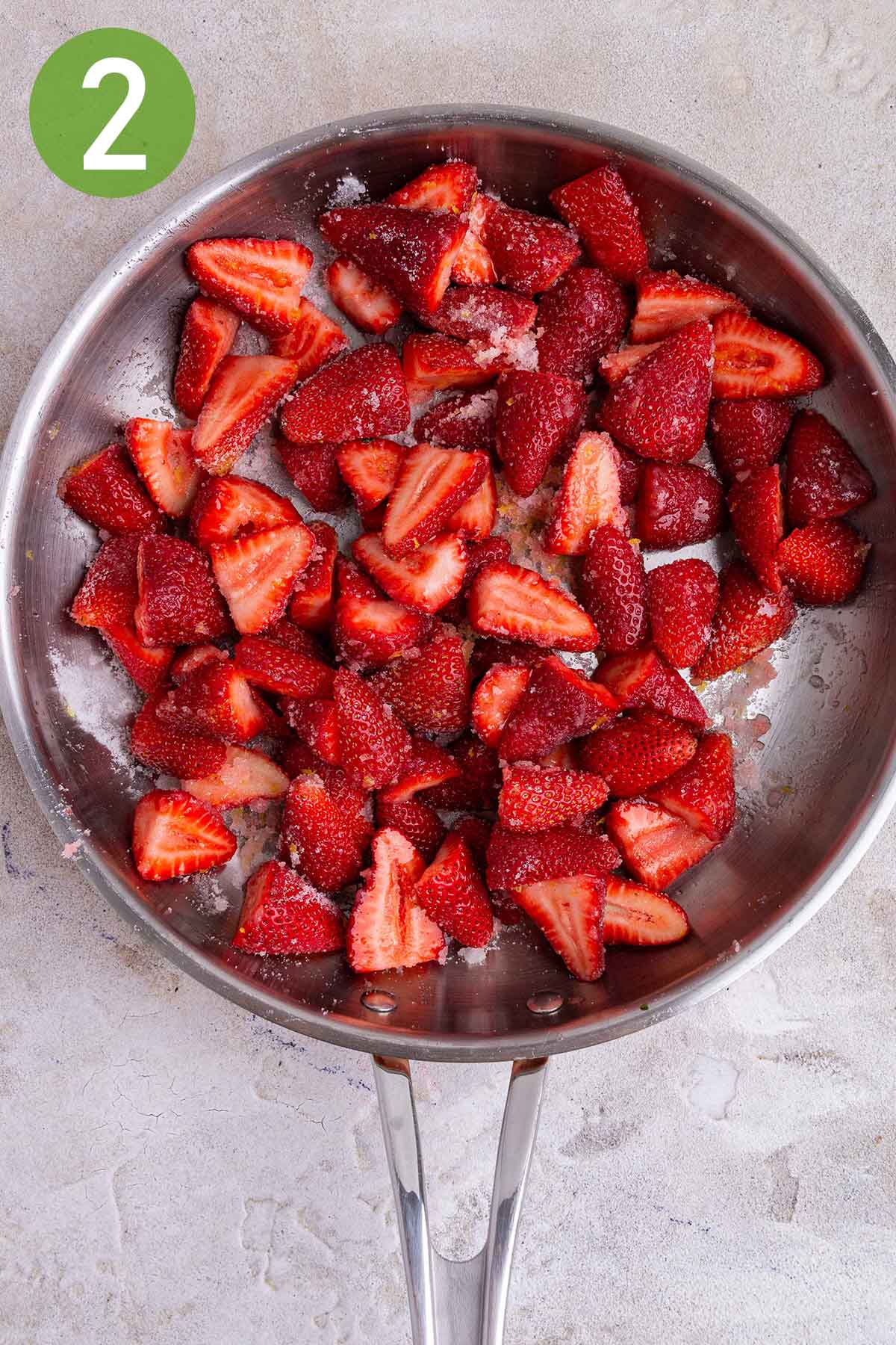 tossing the strawberries with sugar and lemon juice.