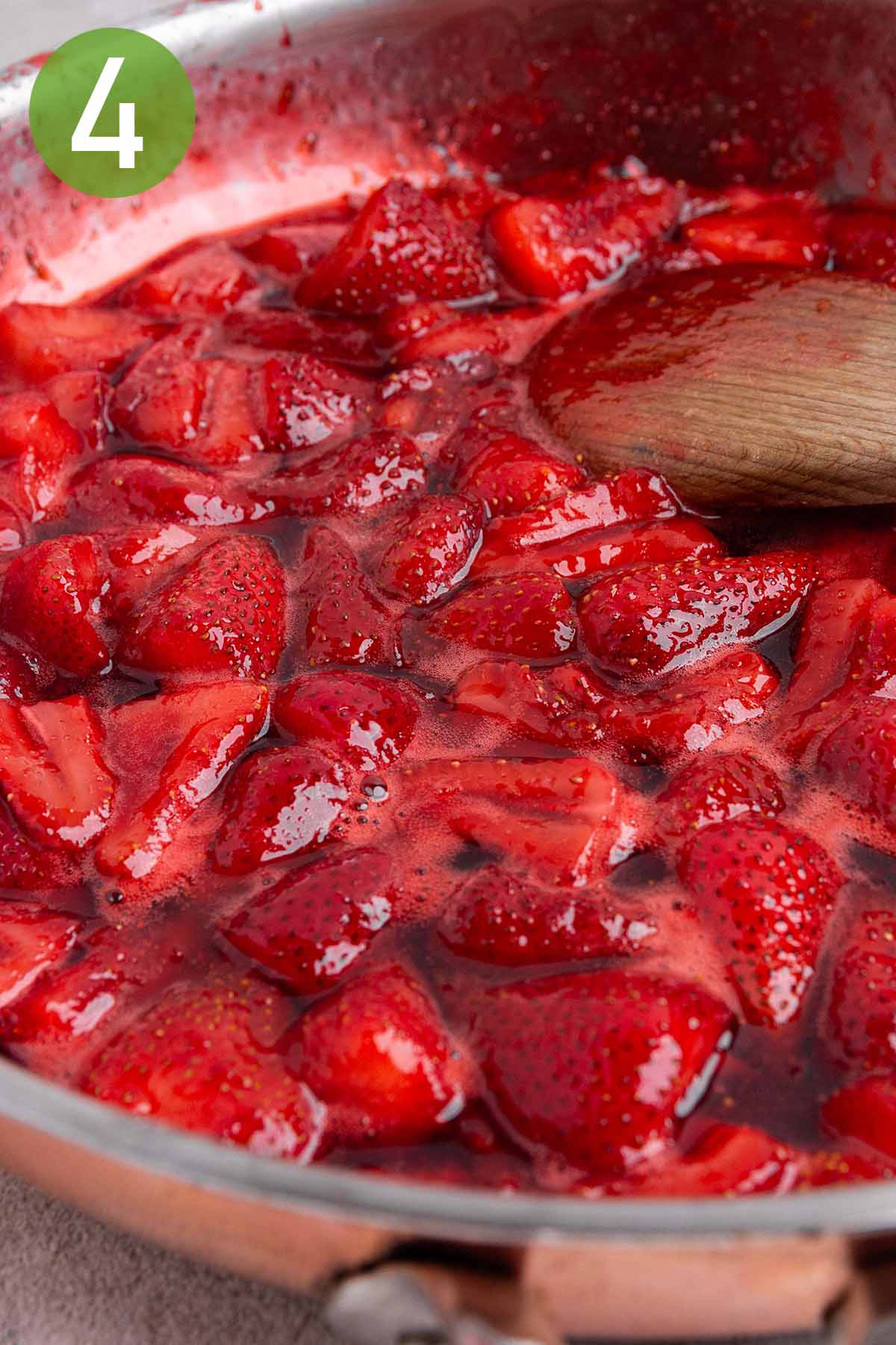 cooking the strawberry jam in a large skillet.