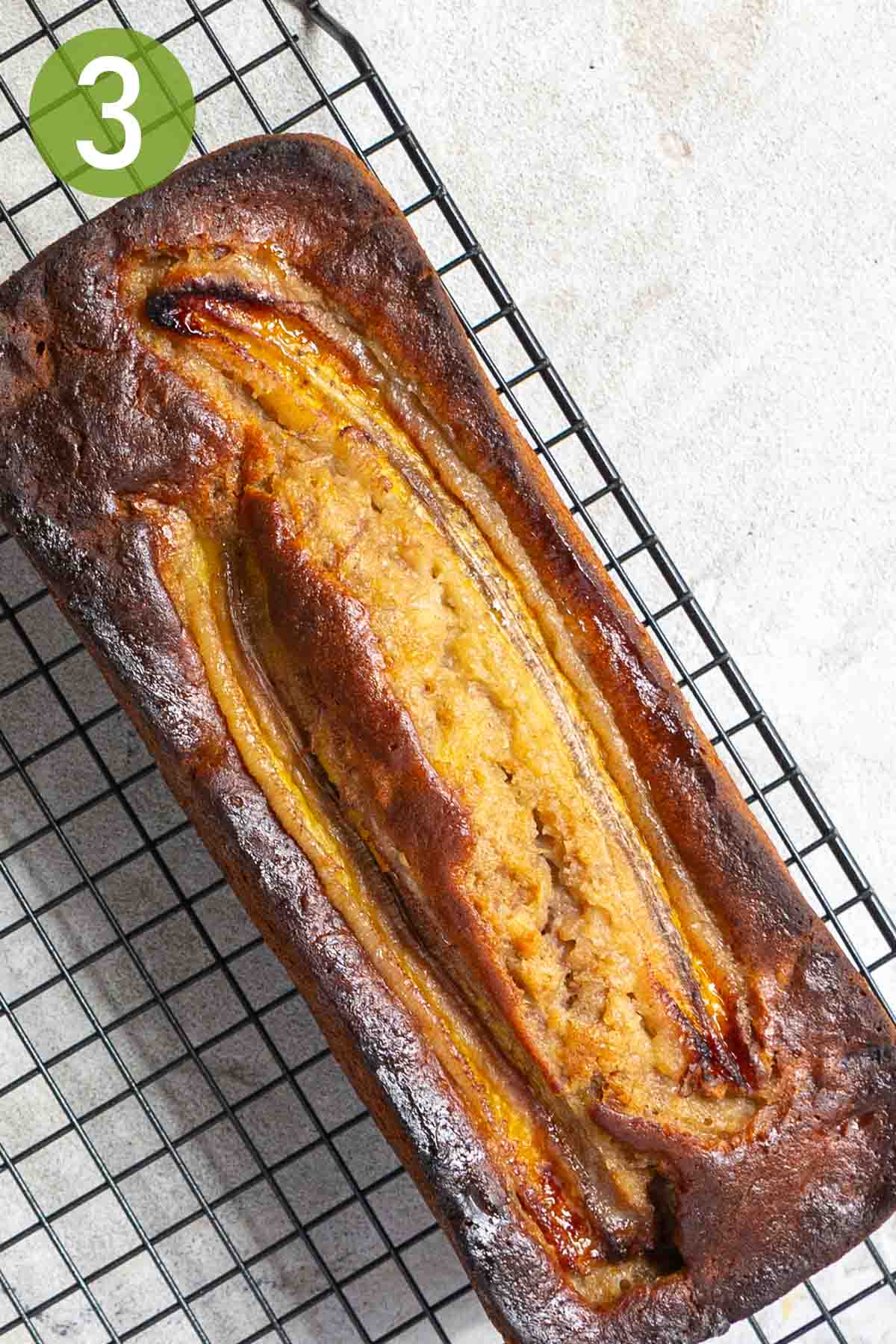 loaf of banana bread on a wire rack.