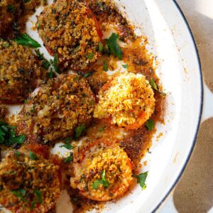 breadcrumb stuffed tomatoes in a cast iron pot.