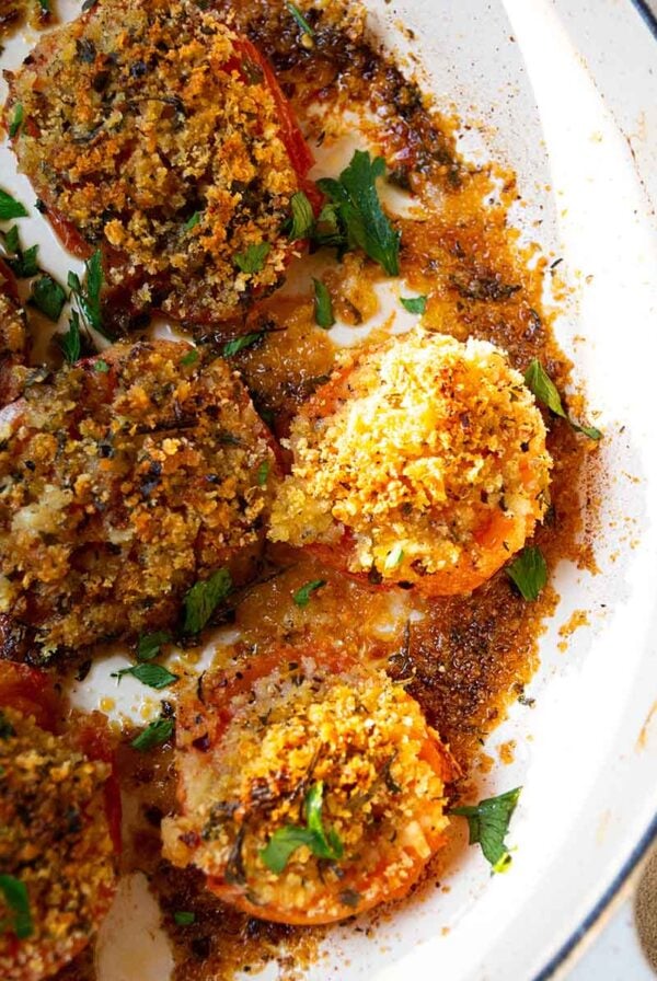 breadcrumb stuffed tomatoes in a cast iron pot.