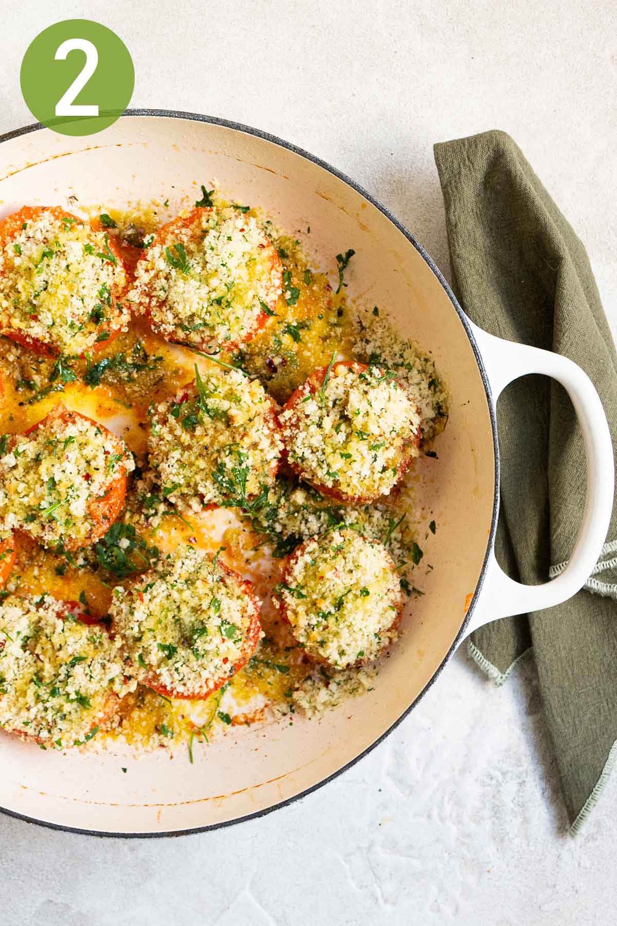 stuffing the tomatoes with the breadcrumb mixture.