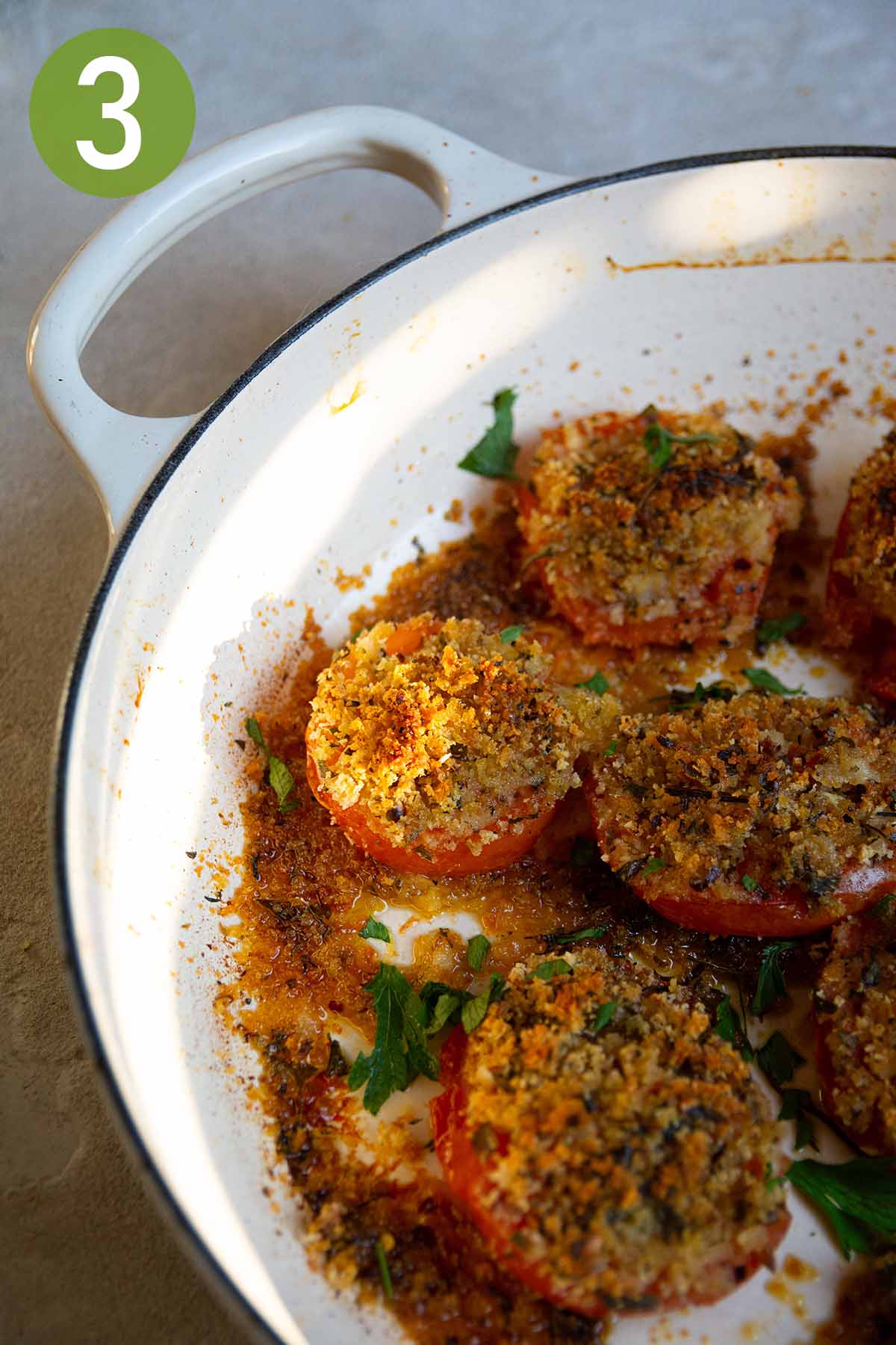 baked stuffed tomatoes in a cast iron pot.
