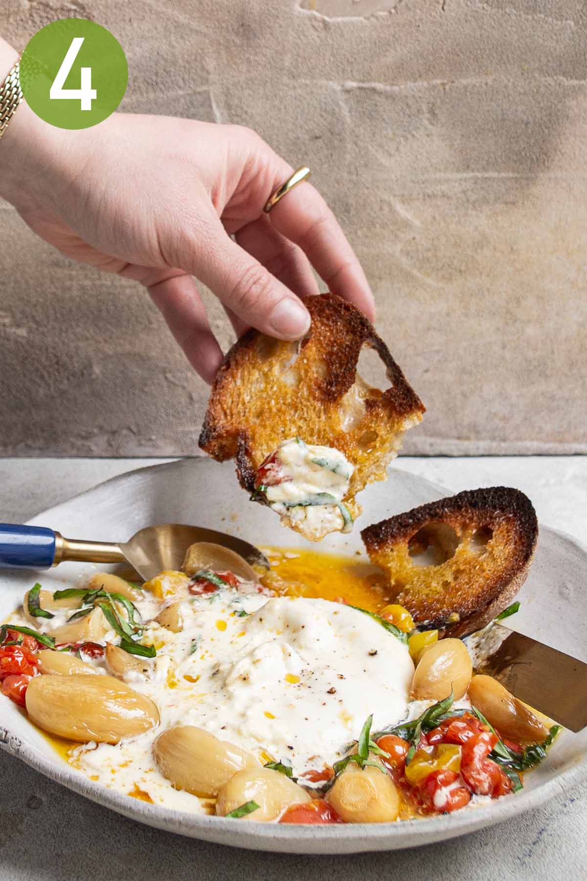 spreading the melted burrata on toasted bread.