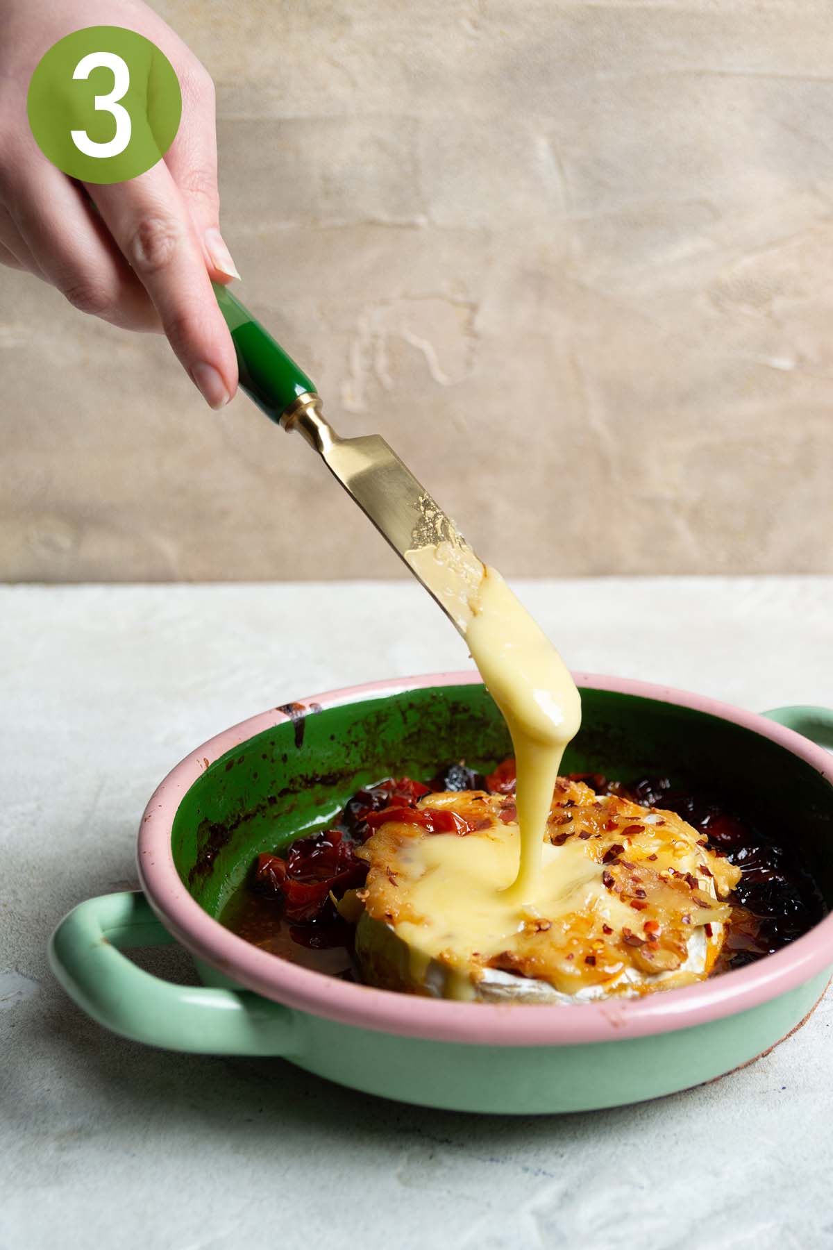 scooping up the melted brie with a knife.