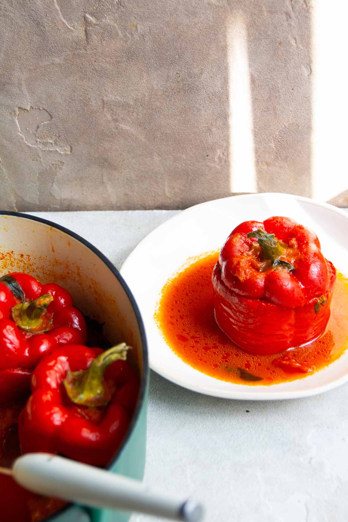 serving a stuffed bell pepper on a white plate.