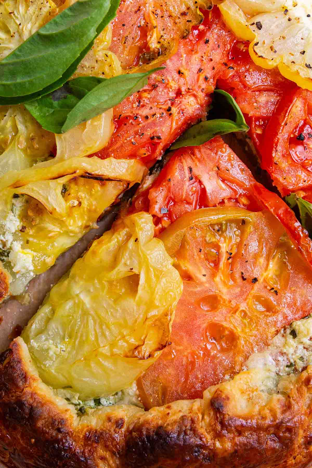 sliced summer tomato tart with fresh basil.