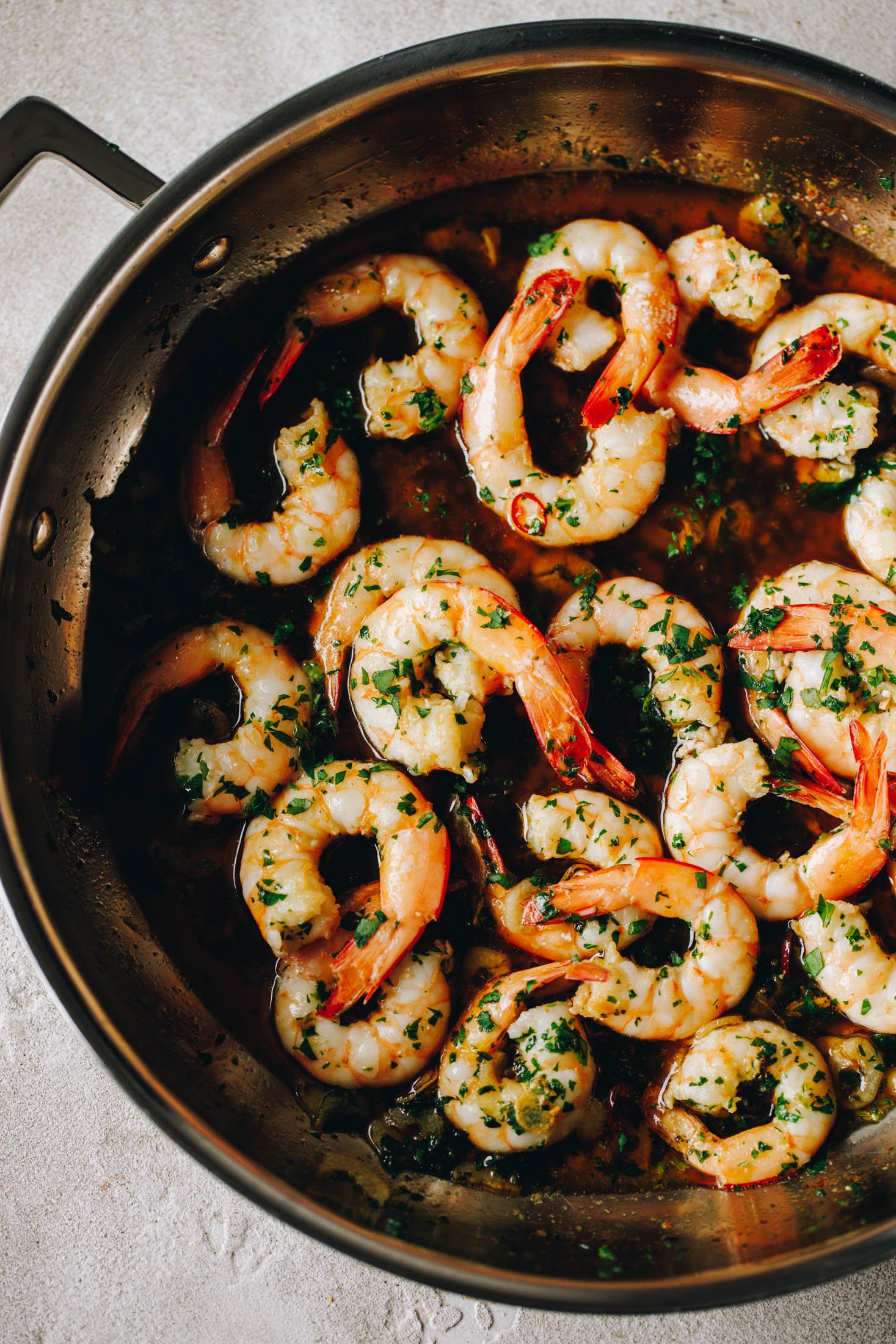 Spanish Garlic Shrimp (Prawns) - Gambas al Ajillo sit in large stainless steel fry pan. 