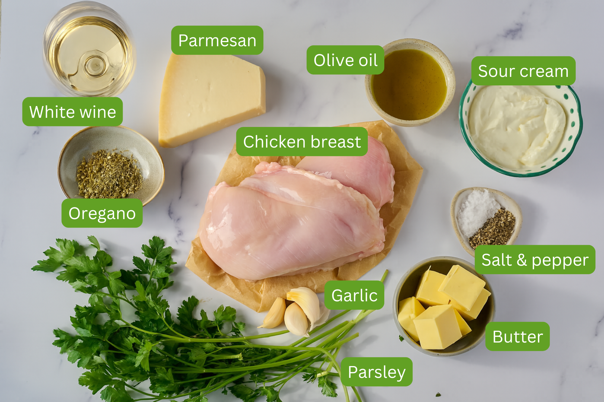 Ingredients for creamy parmesan chicken are shown including white wine, parmesan, olive oil, sour cream, salt and pepper, butter, parsley, garlic, oregano. 