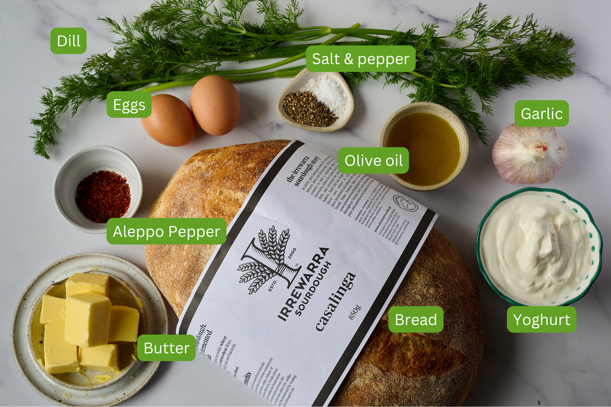List of ingredients shown for turkish eggs. Ingredients include garlic, olive oil, salt and pepper, eggs, dill, aleppo pepper, sourdough, butter and bread. 
