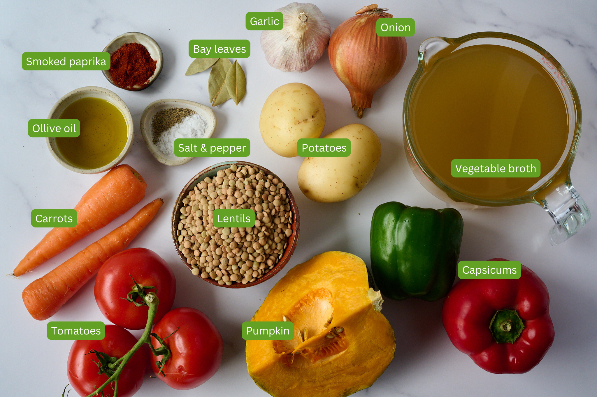 You can see all the ingredients needed for Spanish Lentil Stew (Lentejas). Ingredients include potatoes, garlic, bay leaves, onion, vegetable broth, capsicums, pumpkin, tomatoes, carrots, olive oil, smoked paprika, salt and pepper, lentils