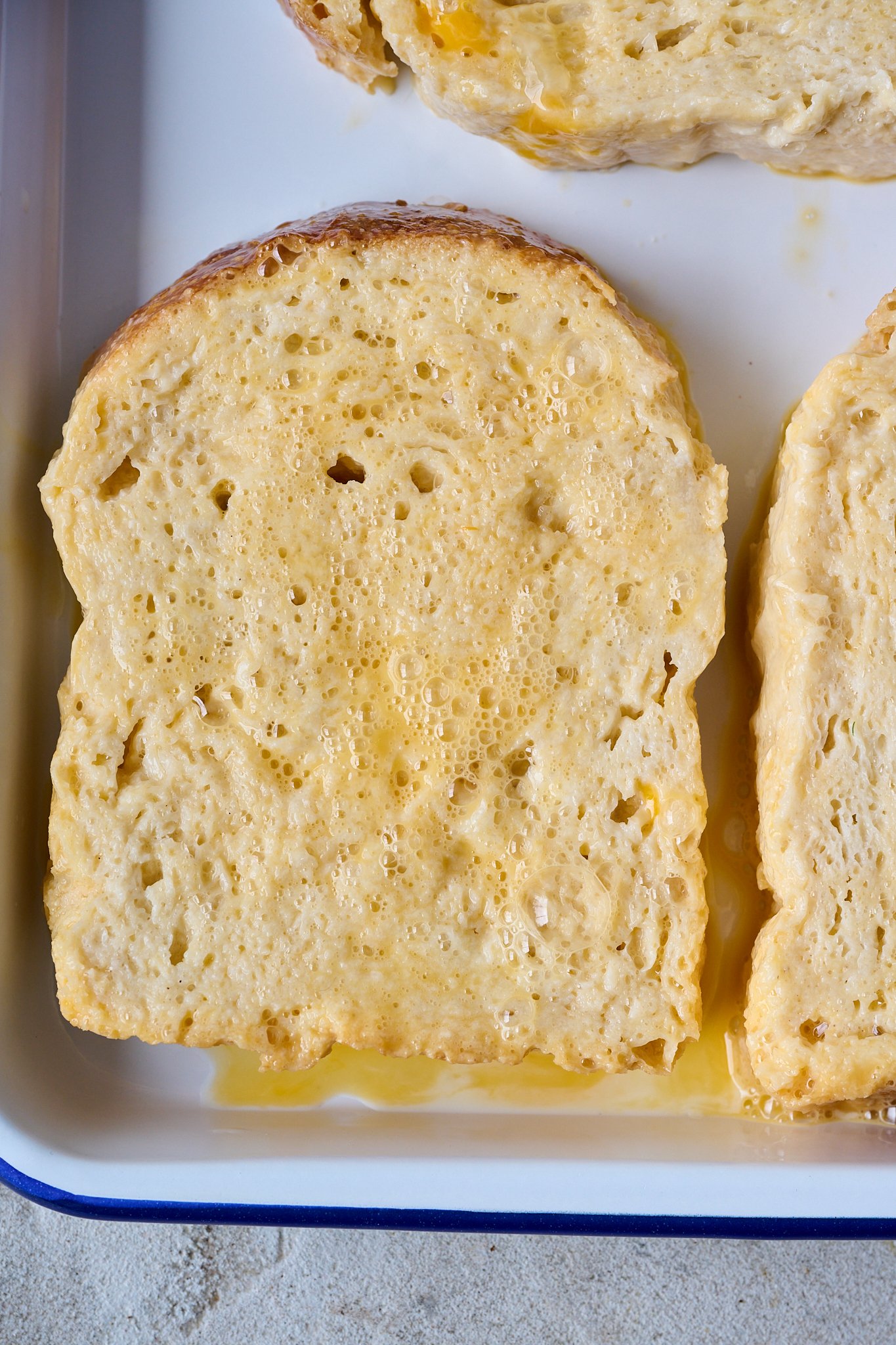 Thick slices of white bread have been dipped into egg