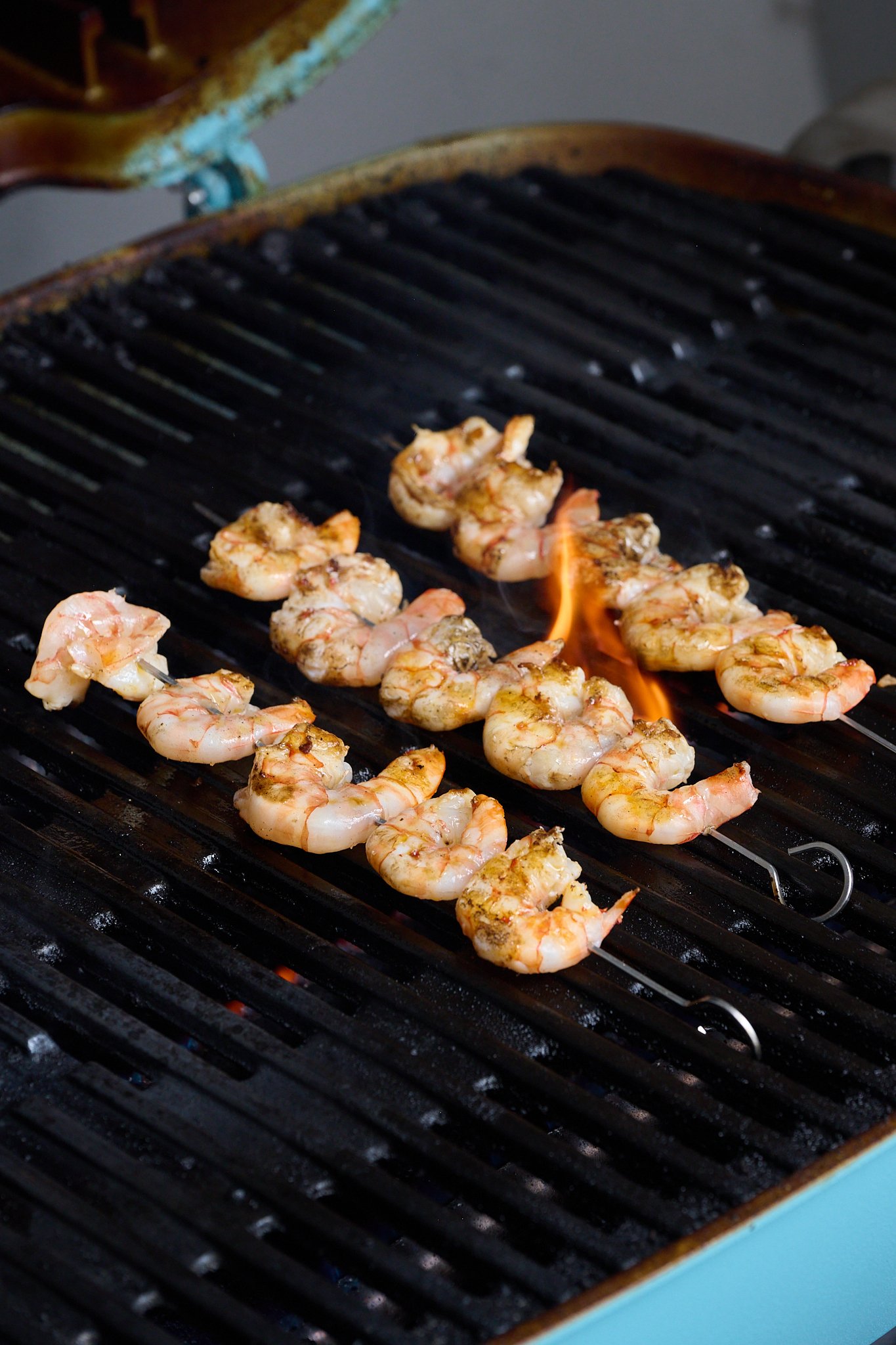 Shrimp are shown on BBQ.