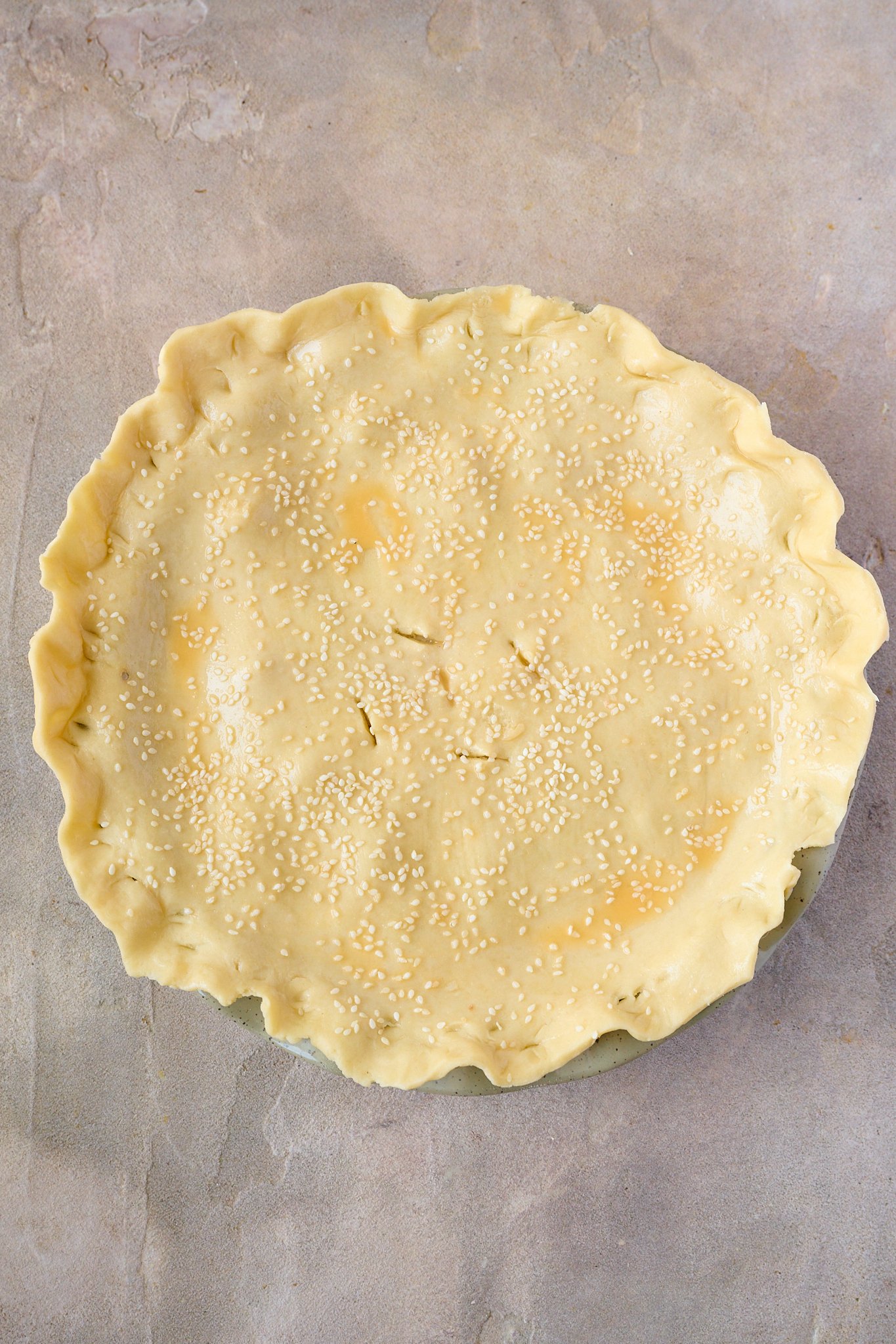Creamy Chicken, Mushroom & Bacon Pot Pie is uncooked and sitting in green pie dish