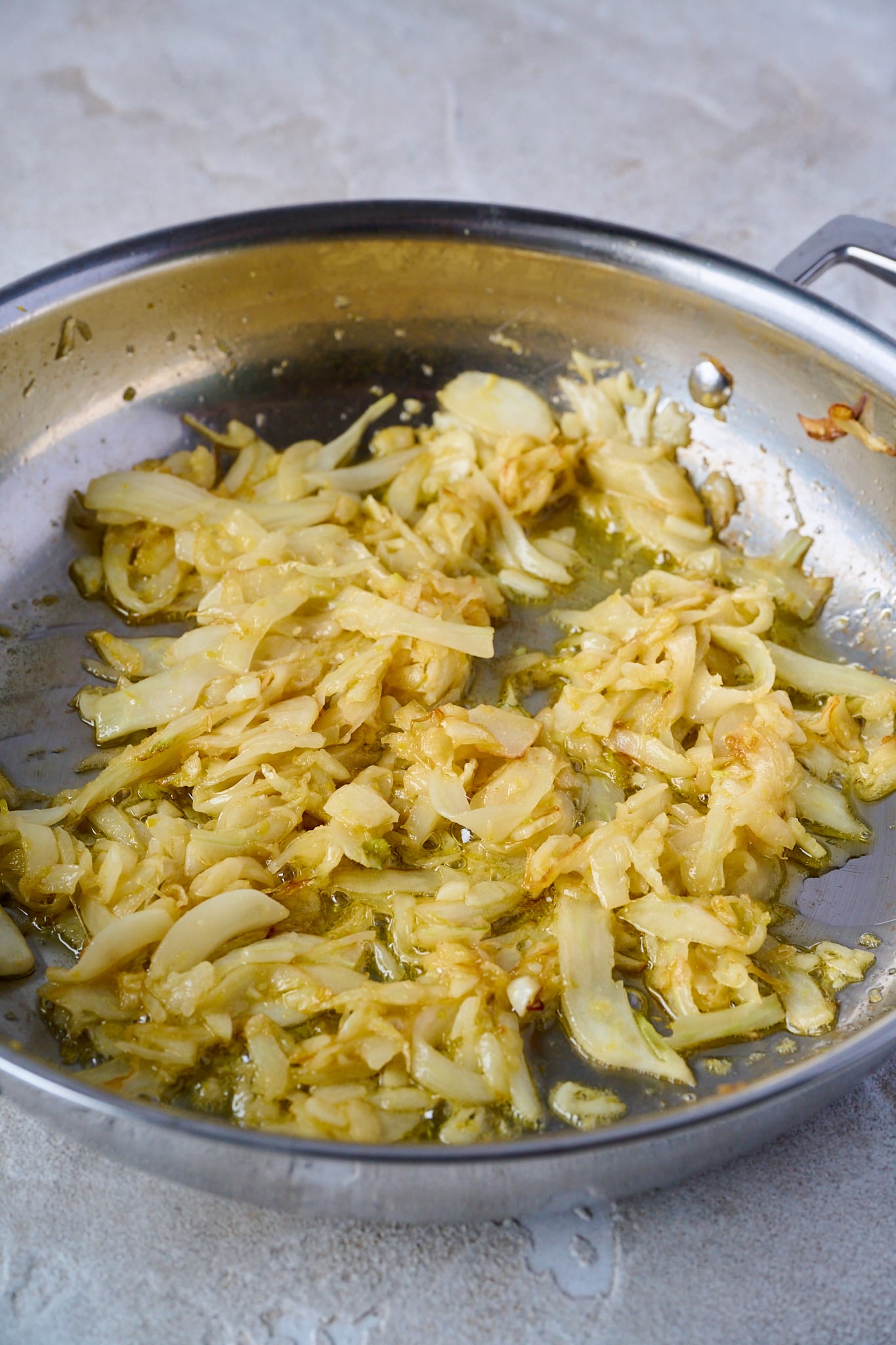 Caramelized Fennel is in large stainless steel pan.