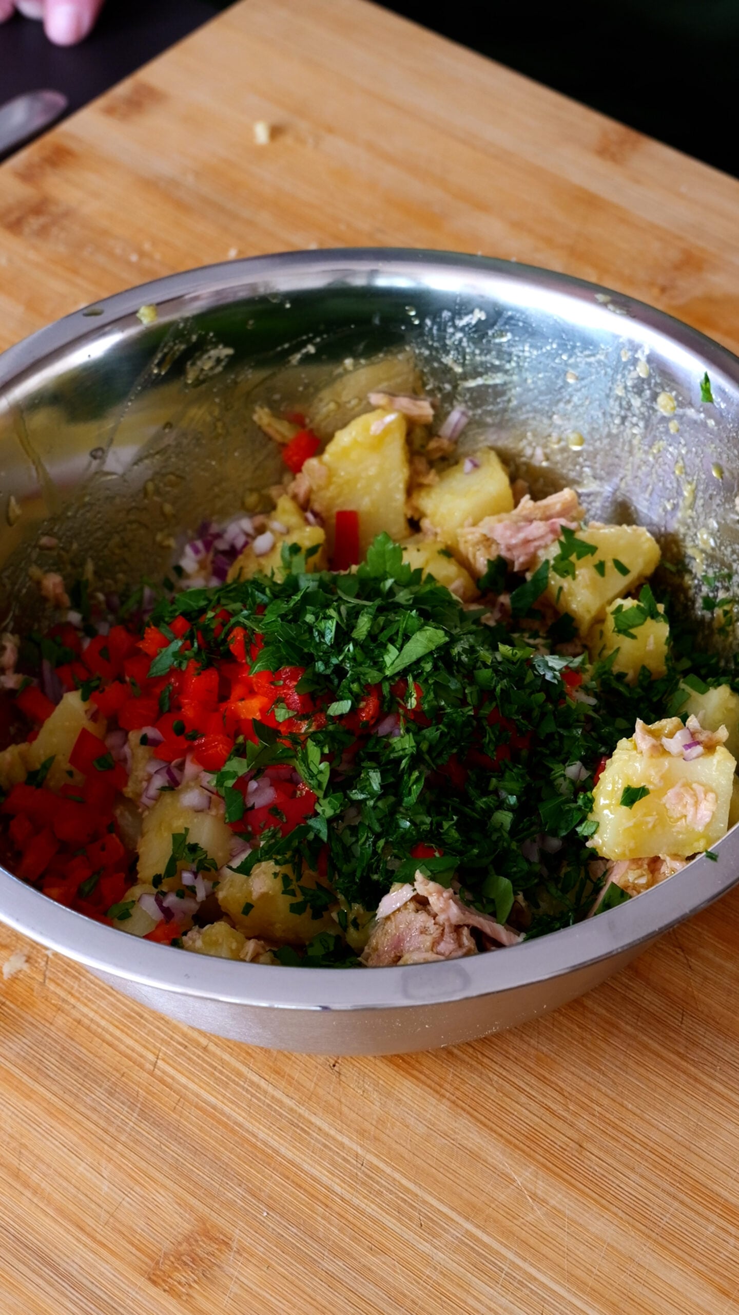 Stainless steel bowl now has capsicum, parsley and red onion in it.